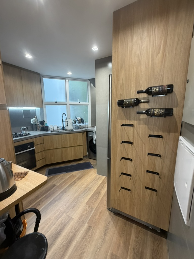 Wood-finished kitchen with wine-storage wall and sink